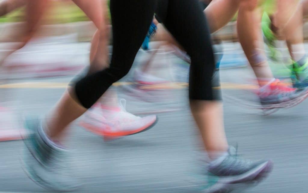 A blurry picture of running legs on a road