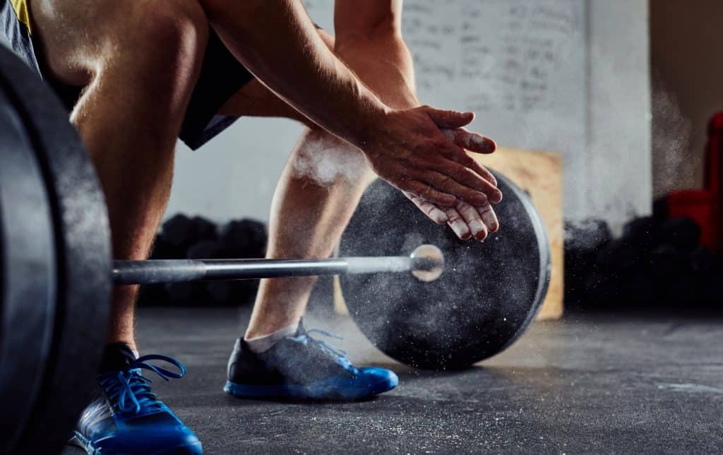 a man preparing to pick up a dumbbell