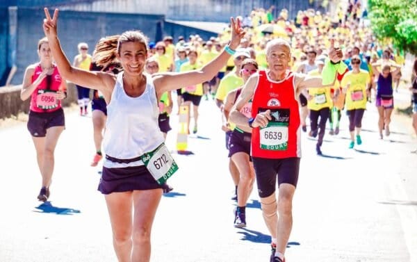 a marathon lady running a marathon and celebrating