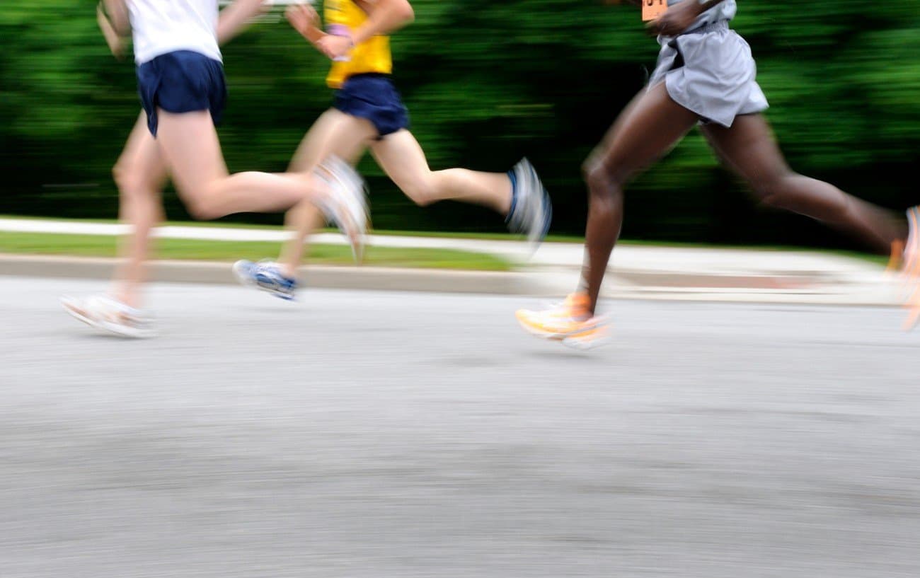 a group of 3 runners on a road