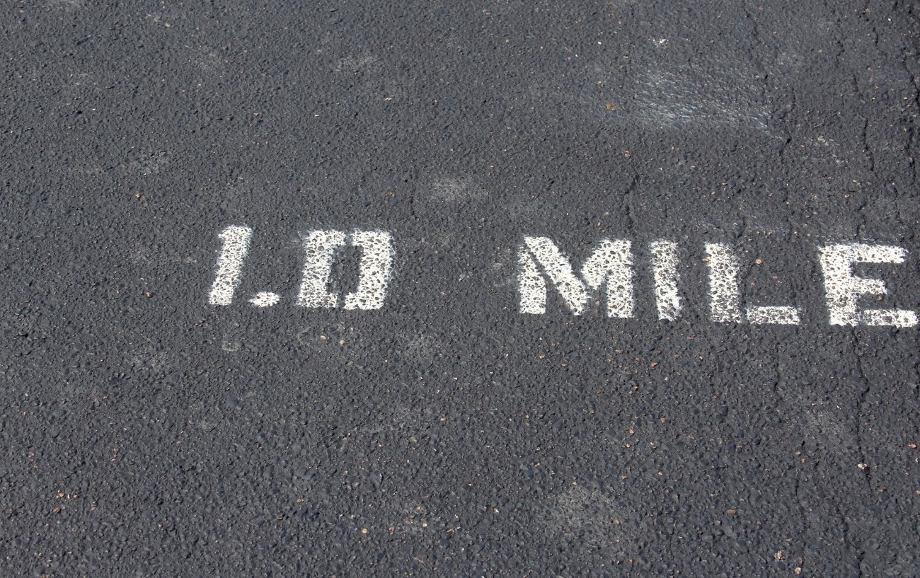 1.0 Mile written on the road.