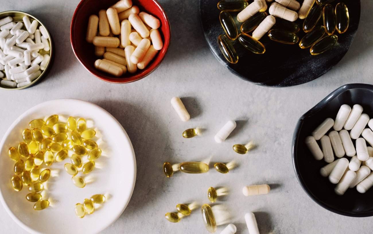 5 different small bowls filled with supplements.