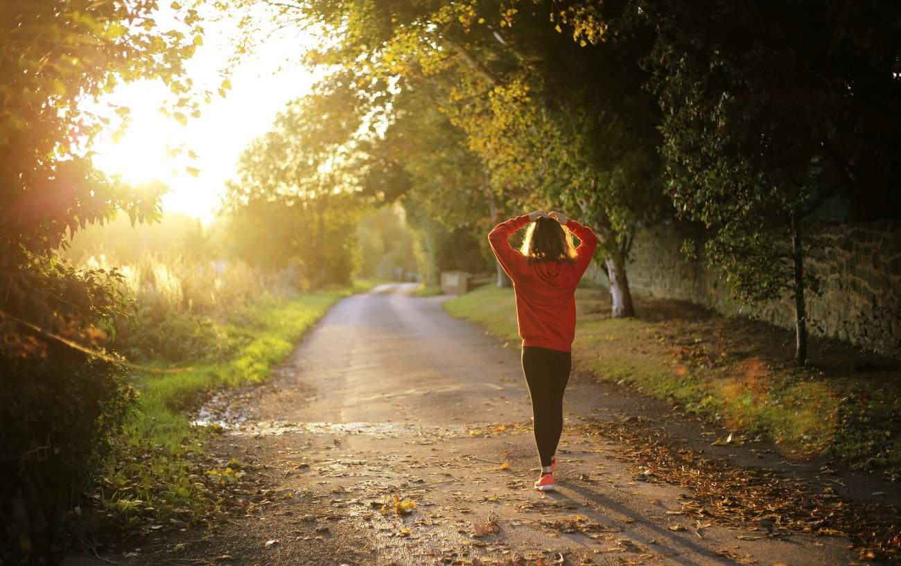 A woman walking on a road.