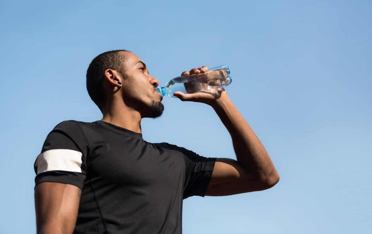 A man drinking a bottle of water.