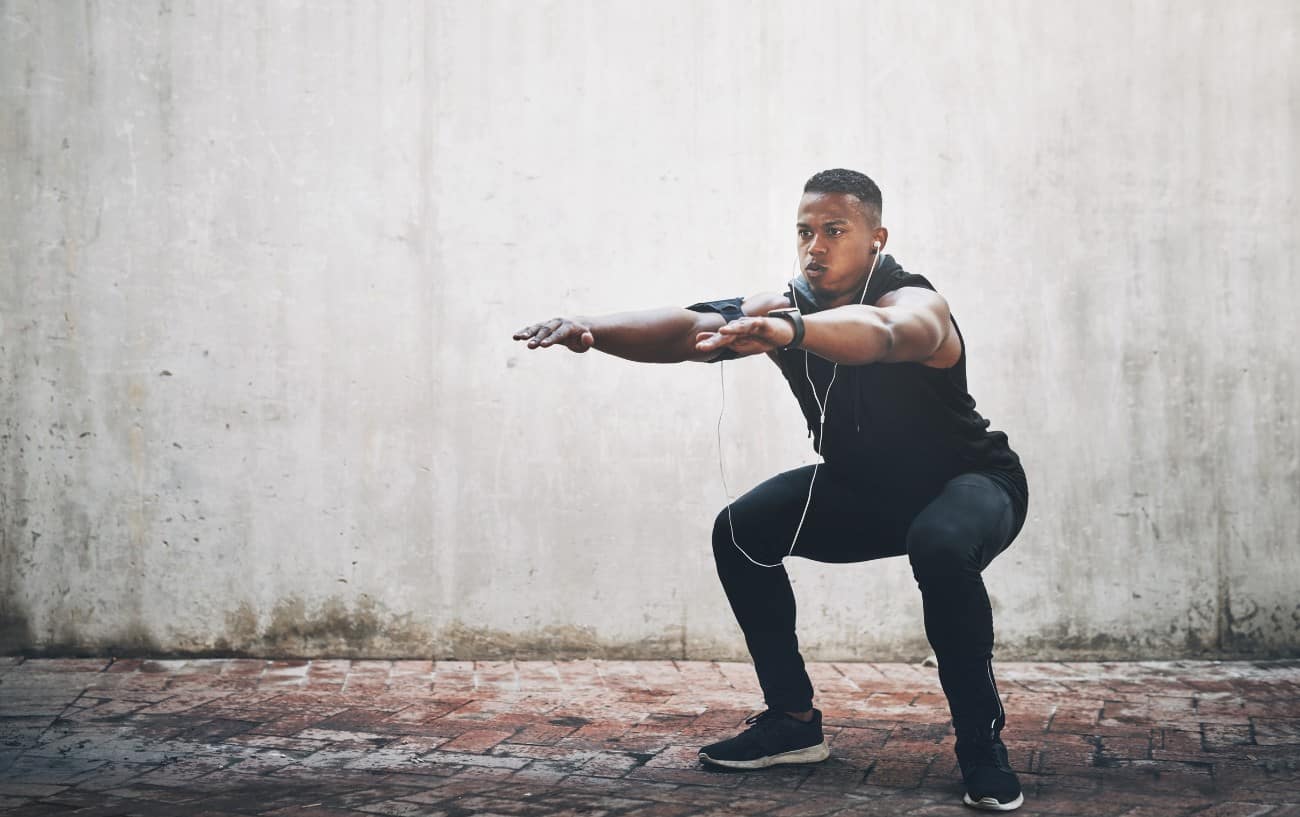 A man doing an isometric squat.