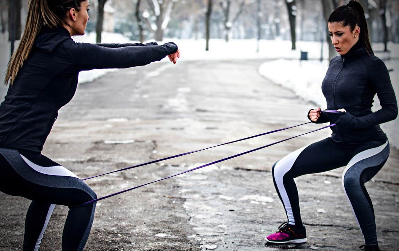 Two people doing squats.