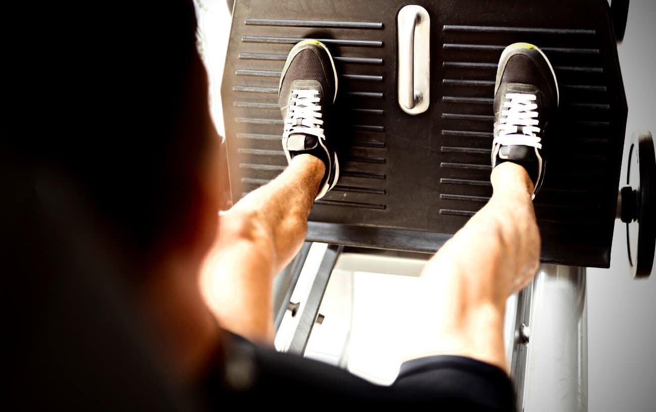 A person doing a leg press exercise.