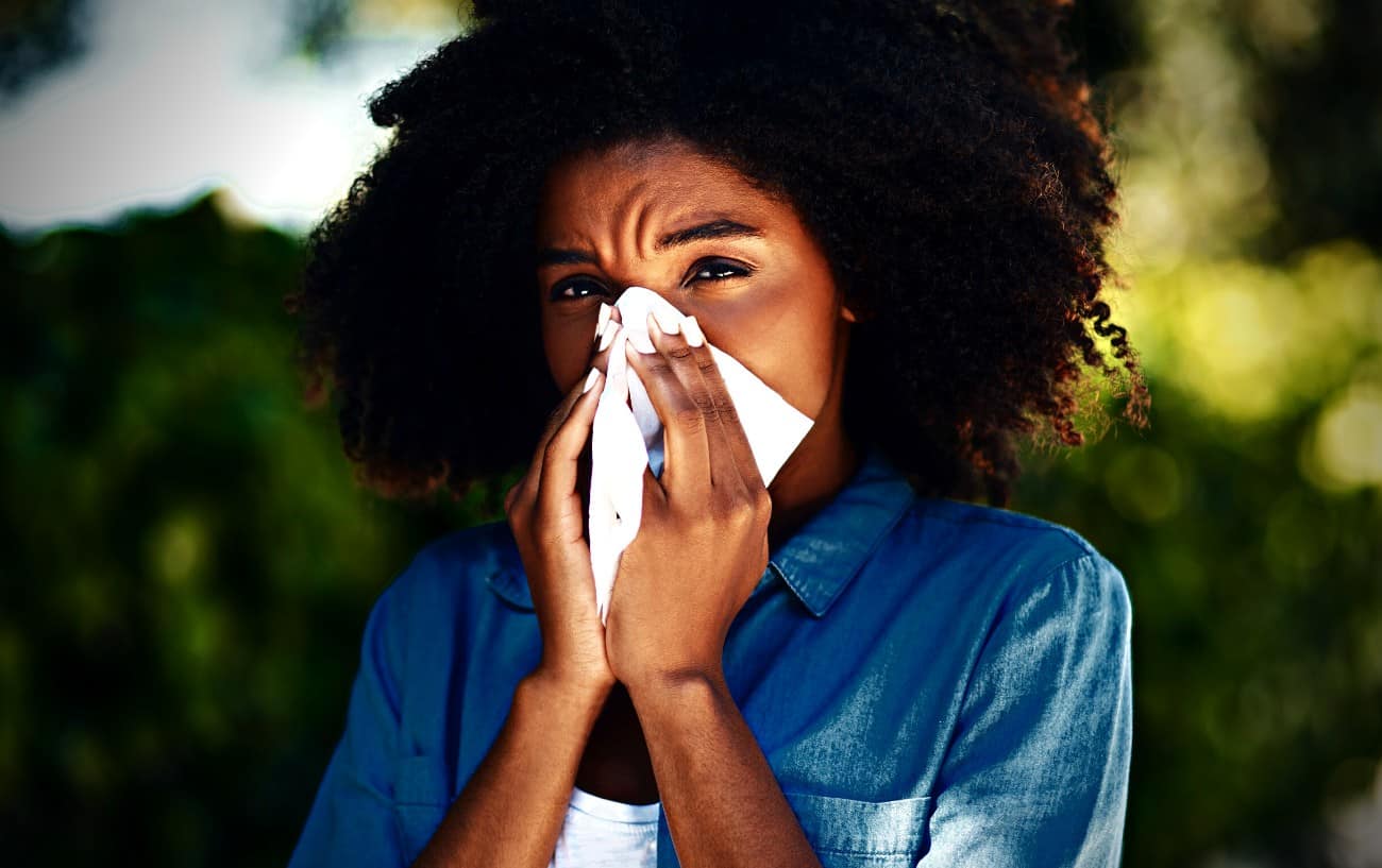 Running With Allergies: 10 Tips To Help You Enjoy Seasonal Running 3 A person with allergies blowing her nose.