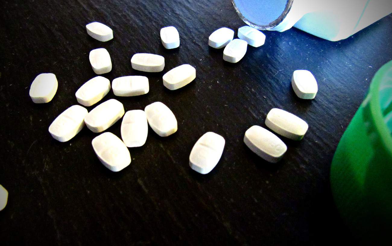 Running With Allergies: 10 Tips To Help You Enjoy Seasonal Running 5 A bottle of medication and pills on a table.