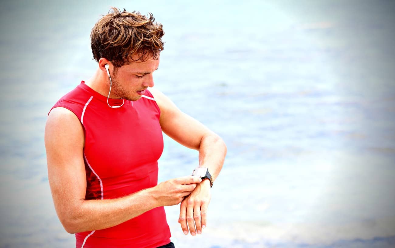 Cardiac Drift: What It Is And How It Affects Your Training 7 A person on the beach looking at their watch.