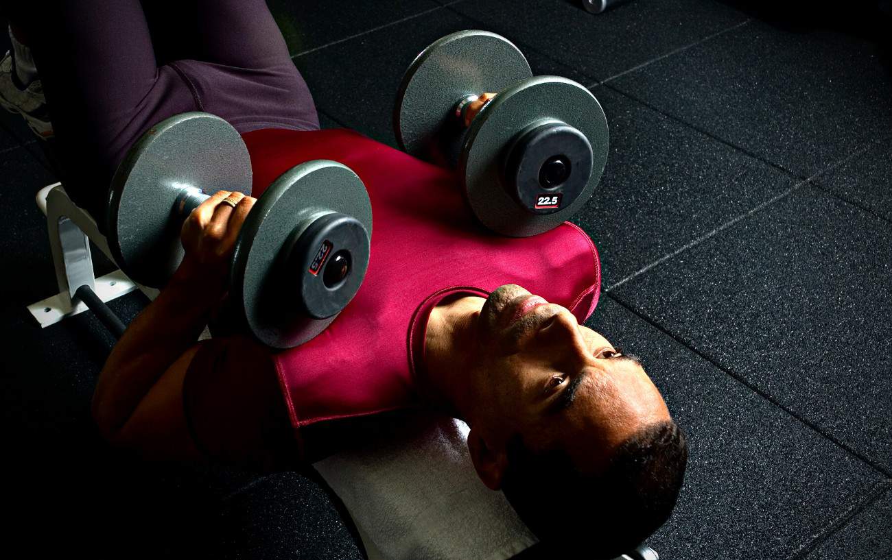 A person doing a chest press.