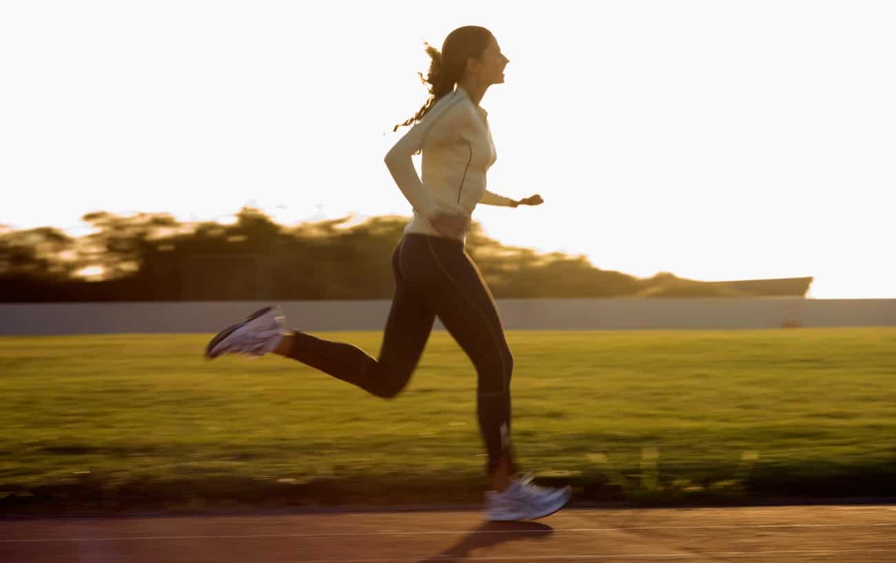 Someone running fast on a track.