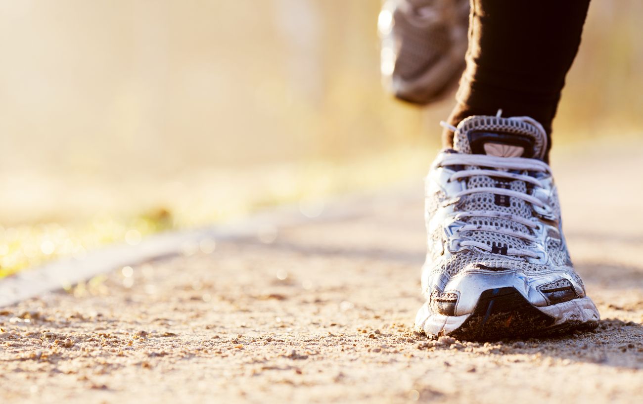 Un primer plano de una zapatilla para correr en la carretera.