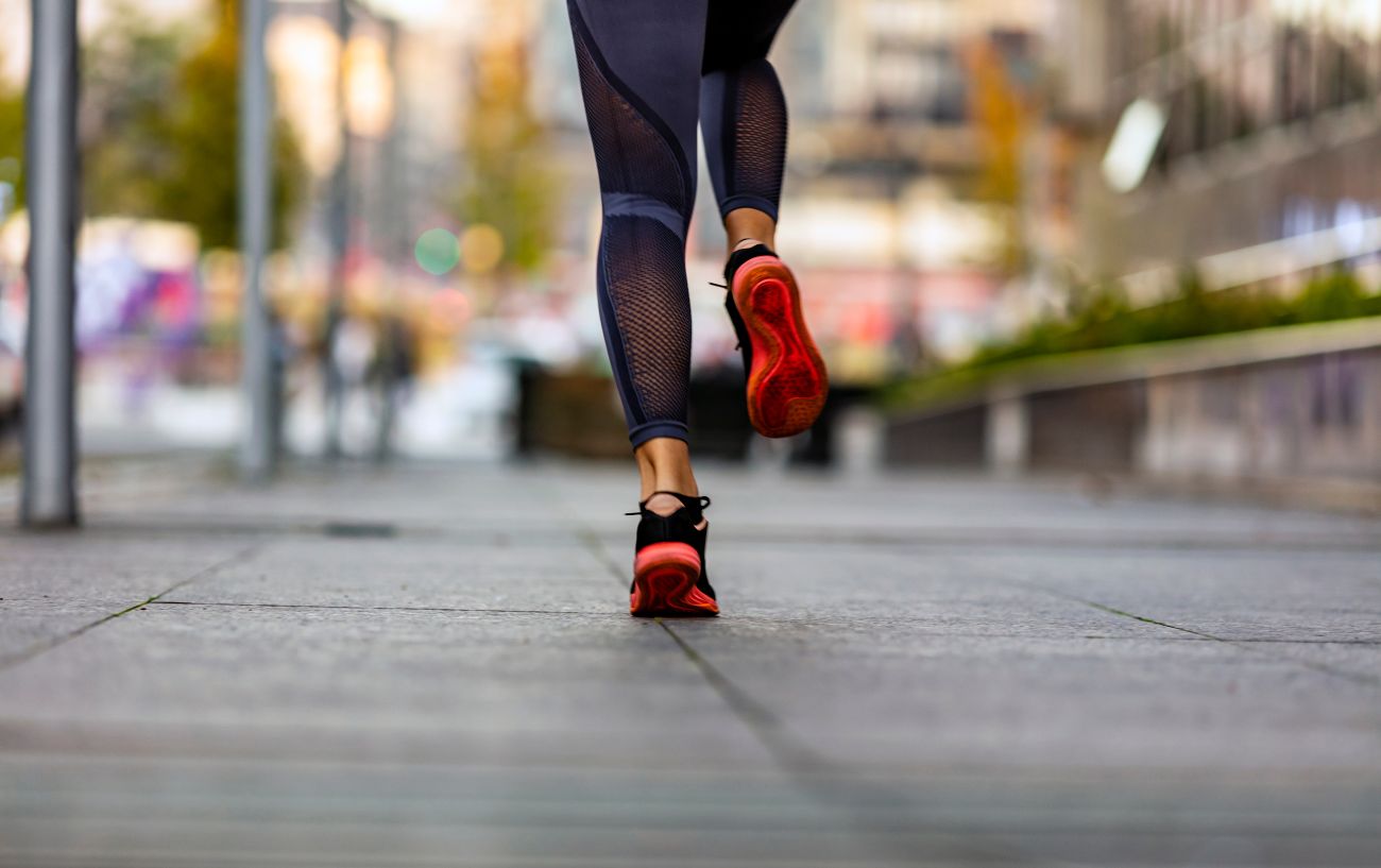 A person running on the sidewalk.