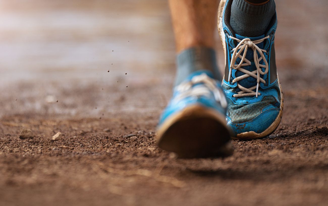 A person's shoes on a trail.