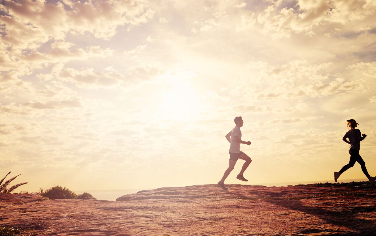 Two people running trail.