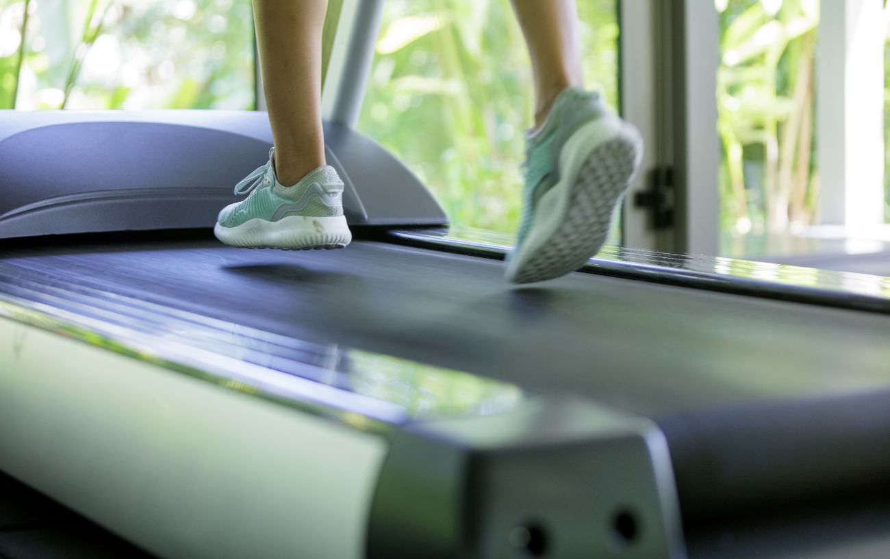 A close-up of a person's feet on a treadmill.