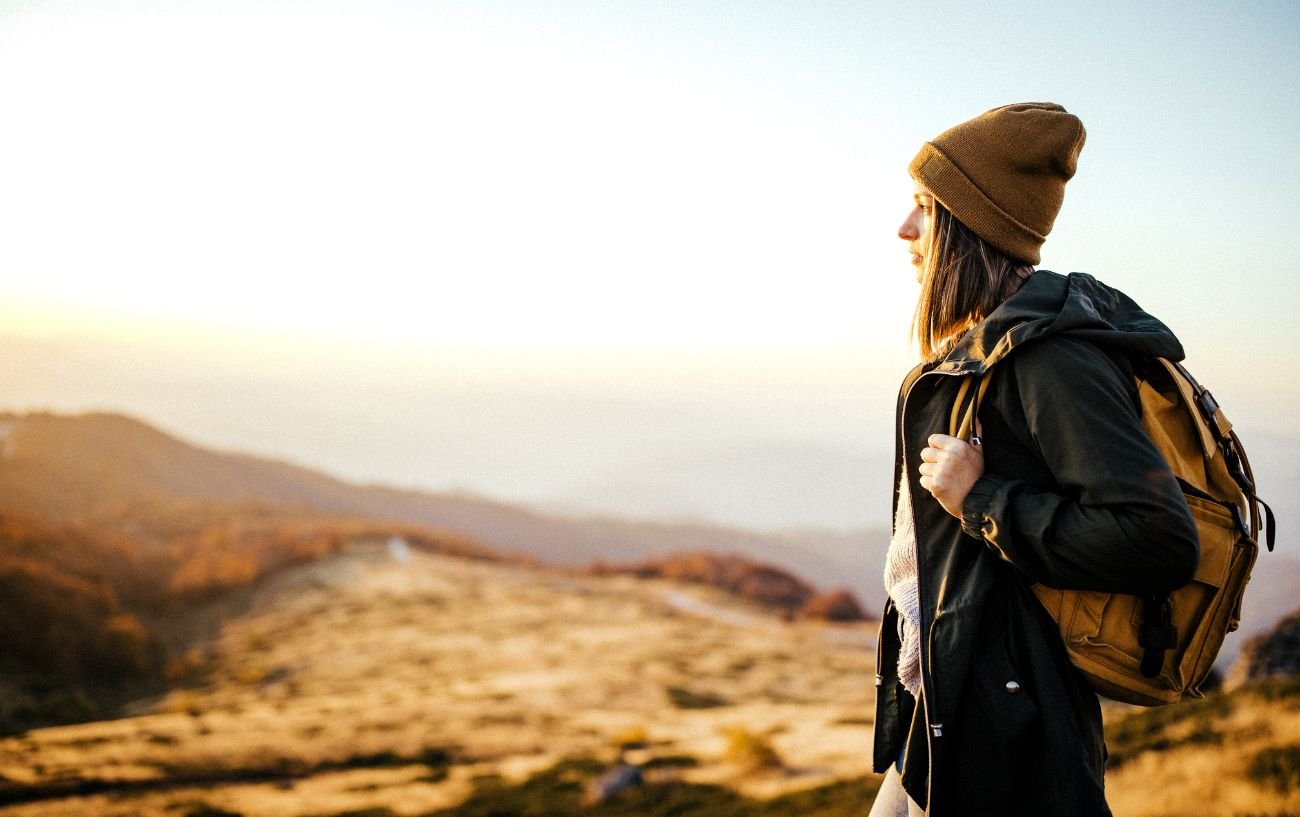 A person solo hiking with a backpack.