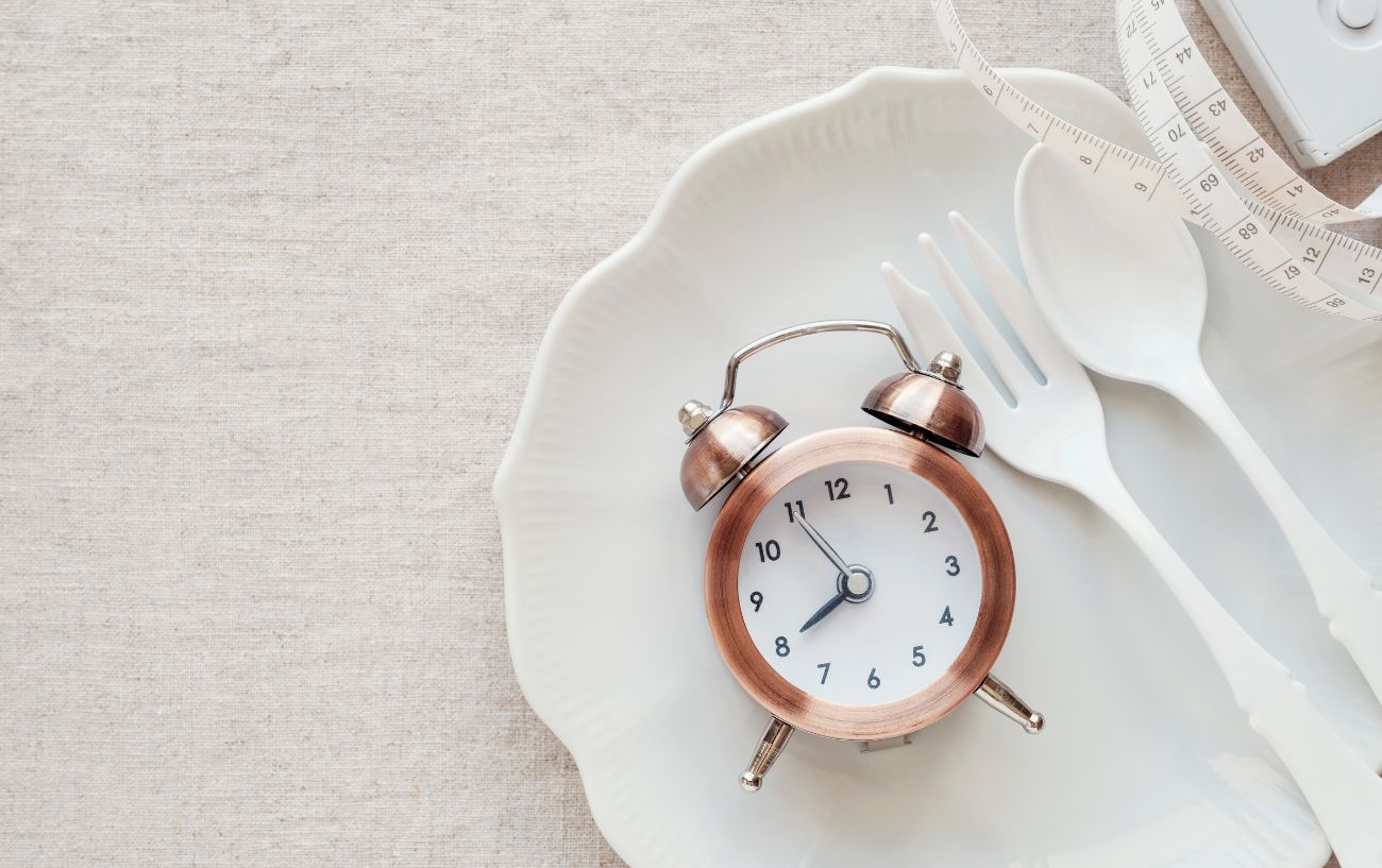 An empty place setting and a clock.