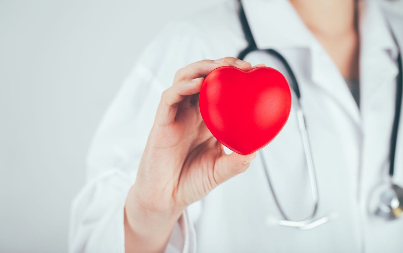 Good News: Cardiac Deaths In Marathons Are Dropping. Here's Why. 3 a doctor holding a heart