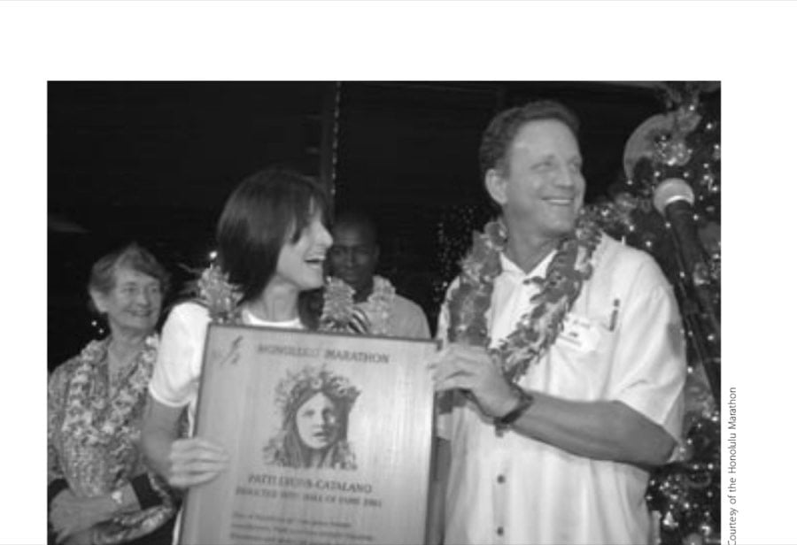 Run to Salvation 21 Honolulu Marathon Association president Jim Barahal presents Patti with her Hall of Fame plaque in 2002.