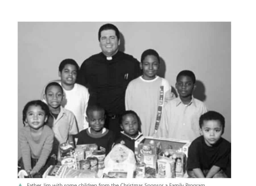 Running For A Higher Purpose 9 Father Jim with some children from the Christmas Sponsor a Family Program.