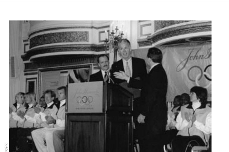 From left, B.A.A. Executive Director Guy Morse, B.A.A. President Thomas Grilk, and John Hancock Sports & Event Marketing Asst. VP Robert Friedman at press conference with elite athletes sitting.