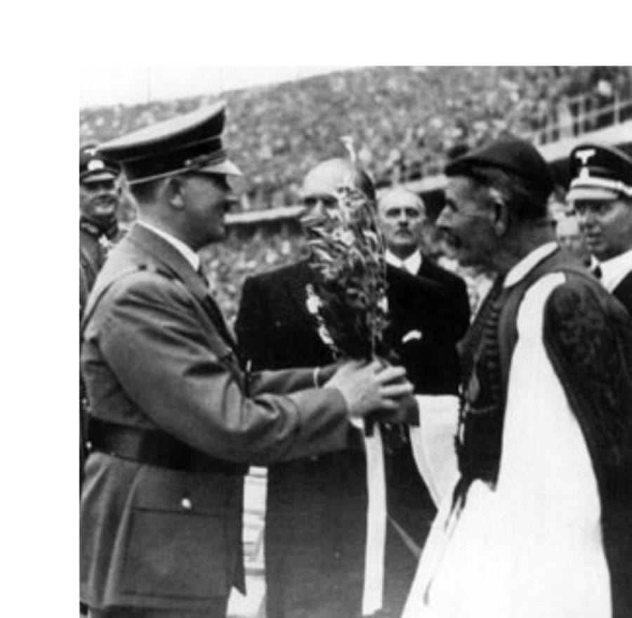 The Naziolympics 11 Spiridon Louis, winner of the marathon in the 1896 Games, presents an olive branch from the Sacred Grove of Zeus at Olympia to the host of the 1936 Games.