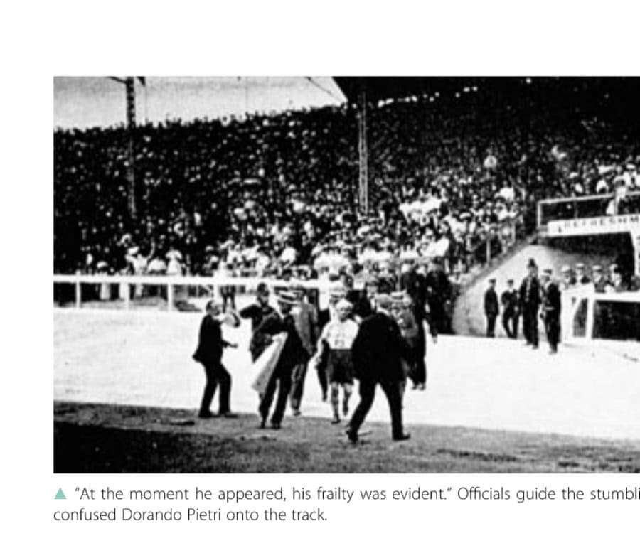 "At the moment he appeared, his frailty was evident." Officials guide the stumbling and confused Dorando Pietri onto the track.