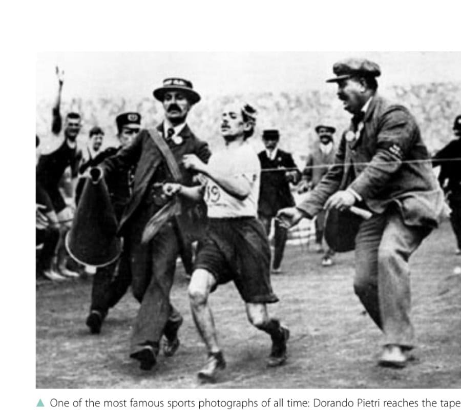 One of the most famous sports photographs of all time: Dorando Pietri reaches the tape, with help.