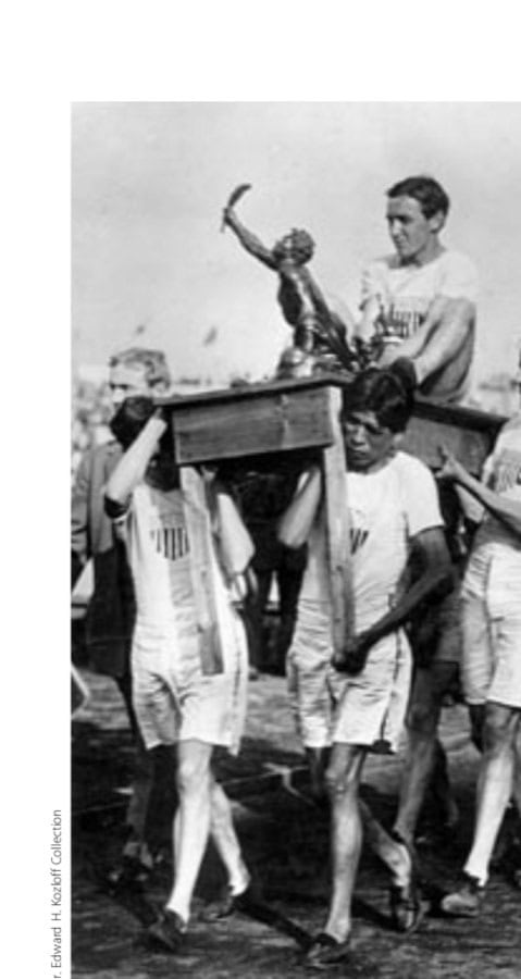 Tactics, judgment, determination, and modesty: American teammates carry Johnny Hayes in deserved triumph, with the "Greek trophy."