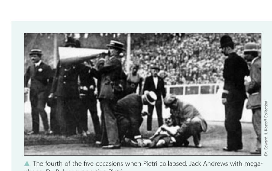 The fourth of the five occasions when Pietri collapsed. Jack Andrews with megaphone, Dr. Bulger supporting Pietri.