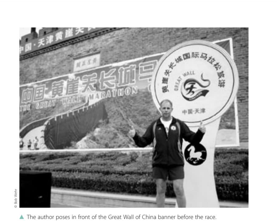 How Running Saved My Life 7 The author poses in front of the Great Wall of China banner before the race.