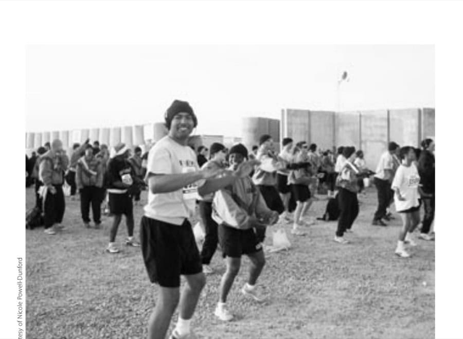 The Aloha Baghdad Marathon 11 Staff Sergeant Michael Thomas and First Lieutenant Tamla Henderson dance to a Hawaiian beat during the prerace warm-up.