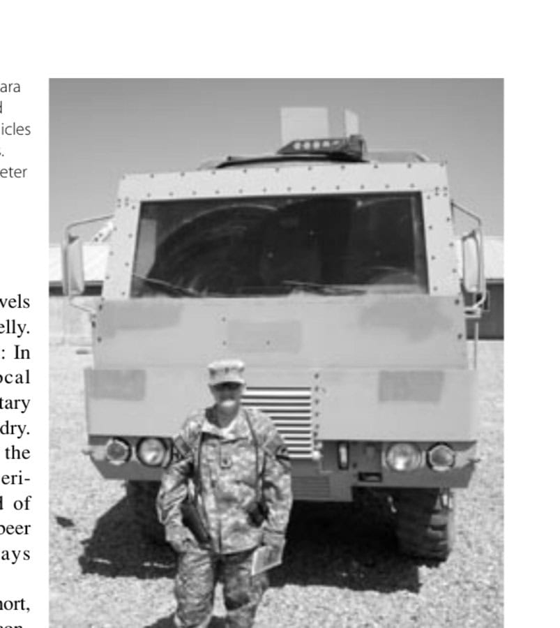 First Lieutenant Sara Day with an armored truck, one of the vehicles her platoon operates. Note the nine-millimeter Beretta pistol in her shoulder harness.