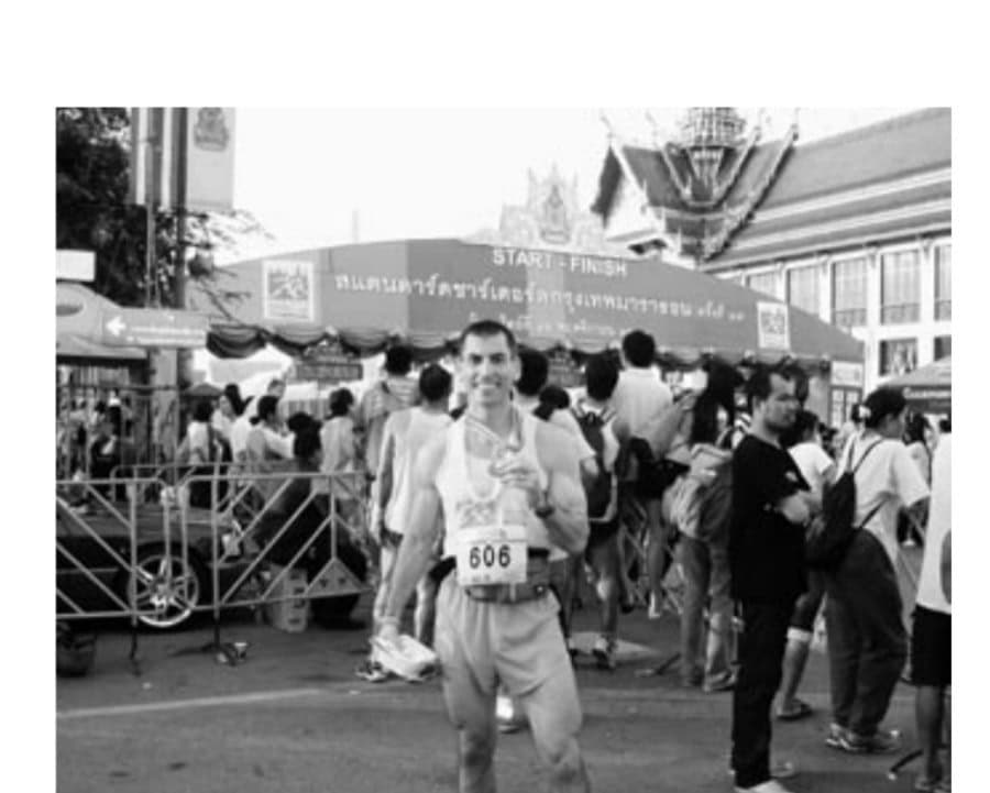 The author strikes a familiar runners pose: showing off the finishers medal.