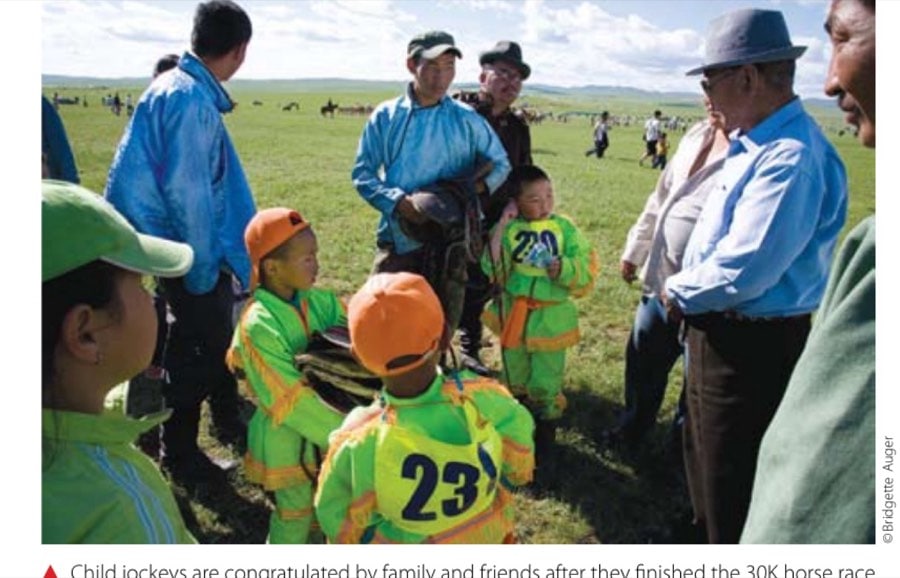 Child jockeys are congratulated by family and friends after they finished the 30K horse race during the Naadam Festival in Mongolia.
