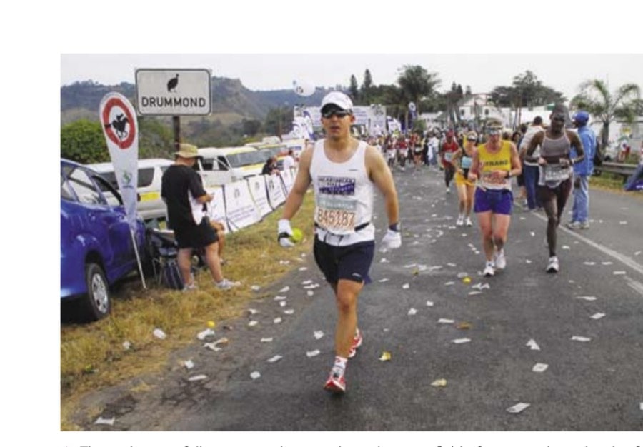 The Endless Run 14 The author carefully navigates his way through a minefield of water sachets shortly after reaching the midway point at Drummond. Runners who have the misfortune of stepping on these liquid bomblets risk soaking their feet.