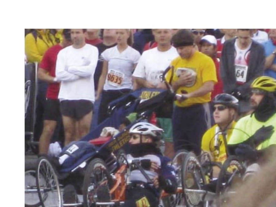 Pushing To The Finish Line 9 David Slomkowski, James Banks, and the other runners honor the National Anthem before the start of the Baltimore Marathon.