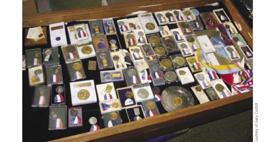 A sampling of some of Ted's medals in a display case that was always in the living room. Some of the medals have been sent to ultrarunners such as Scott Jurek.