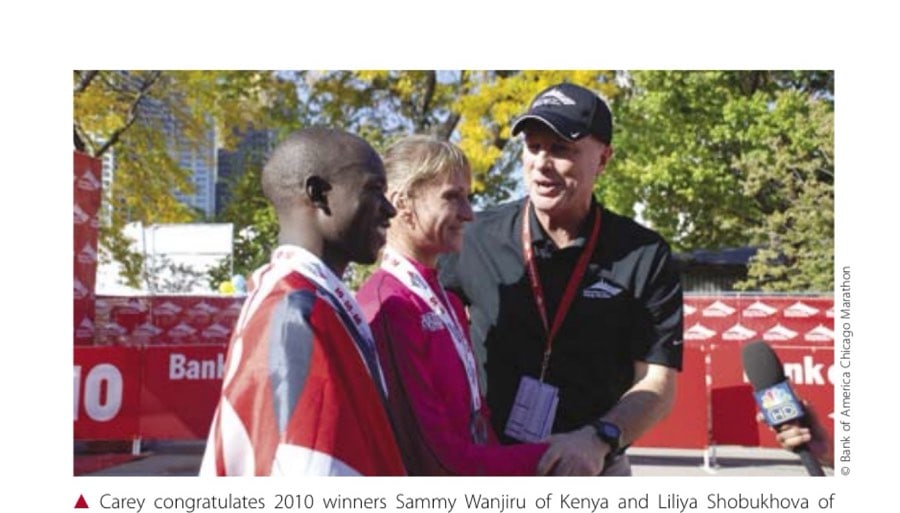 Carey congratulates 2010 winners Sammy Wanjiru of Kenya and Liliya Shobukhova of Russia.