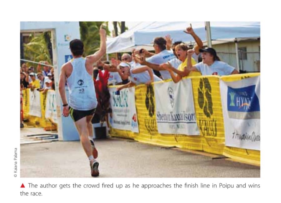 Mile 20, The Seawall, And Loving It All 12 The author gets the crowd fired up as he approaches the finish line in Poipu and wins the race.