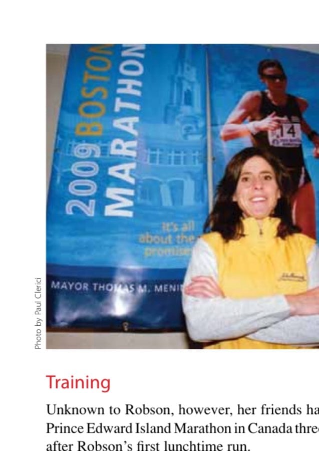 Denise Robson stands in front of a 2009 Boston Marathon banner that bears her picture during the 2008 running when she was the 307th overall and 11th in the open division in a time of 2:45:54.