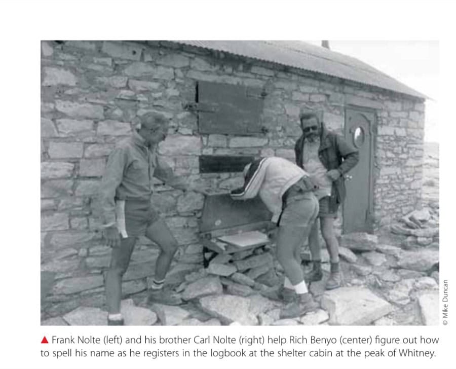 Frank Nolte (left) and his brother Carl Nolte (right) help Rich Benyo (center) figure out how to spell his name as he registers in the logbook at the shelter cabin at the peak of Whitney.