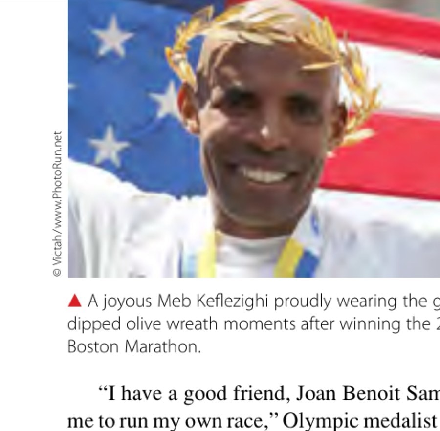 A joyous Meb Keflezighi proudly wearing the gold-dipped olive wreath moments after winning the 2014 Boston Marathon.