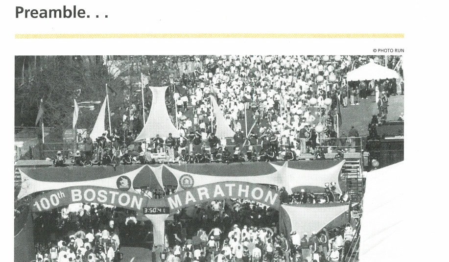 Runners at the 100th Boston Marathon starting area, with the official 100th Boston Marathon banner visible overhead. © Photo Run