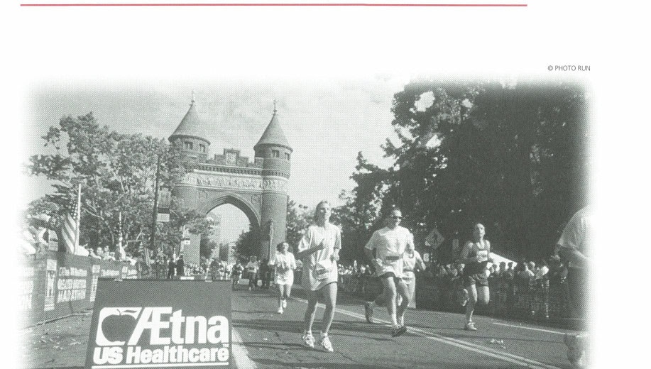 Runners passing under the Aetna US Healthcare banner at the Greater Hartford Marathon start/finish area in Bushnell Park.