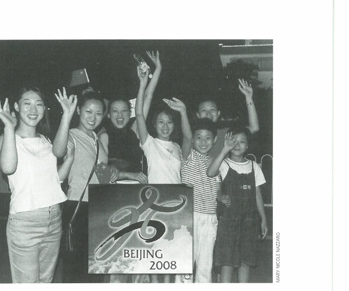 Young party goers celebrate in Tiananmen Square after learning that China was awarded the 2008 Olympic Summer Games.