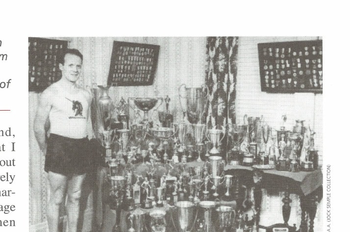Just Call Me Jock 11 Jock stands in his living room with a lifetime's worth of awards.