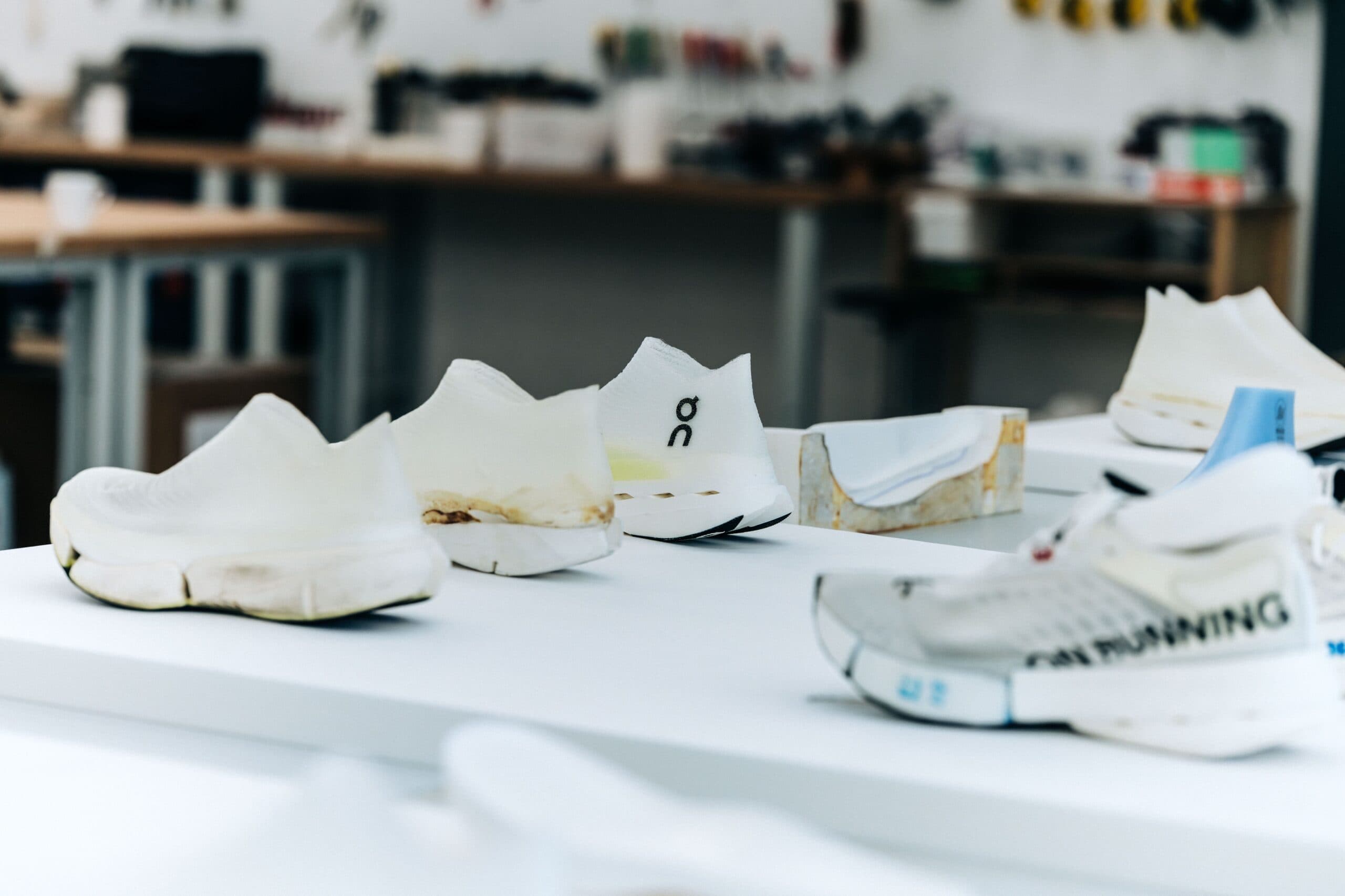 A table of white prototype shoes in On's prototyping lab